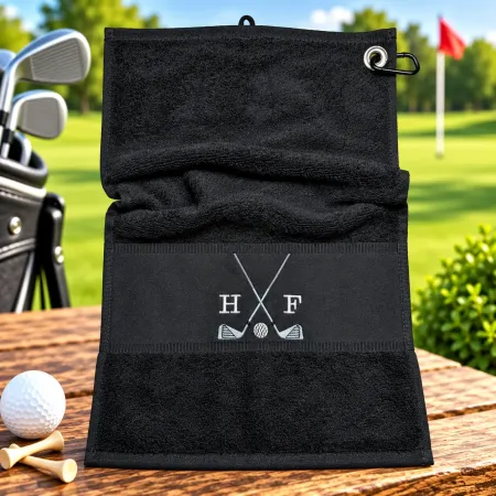 Schwarzes Golfhandtuch mit Initialen H F in Weiß und Golfmotiv bestickt
