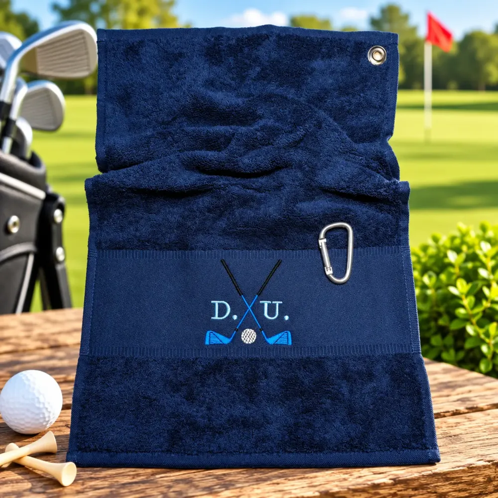 Marineblaues Golfhandtuch mit Initialen D. U. in Hellblau und Golfmotiv bestickt